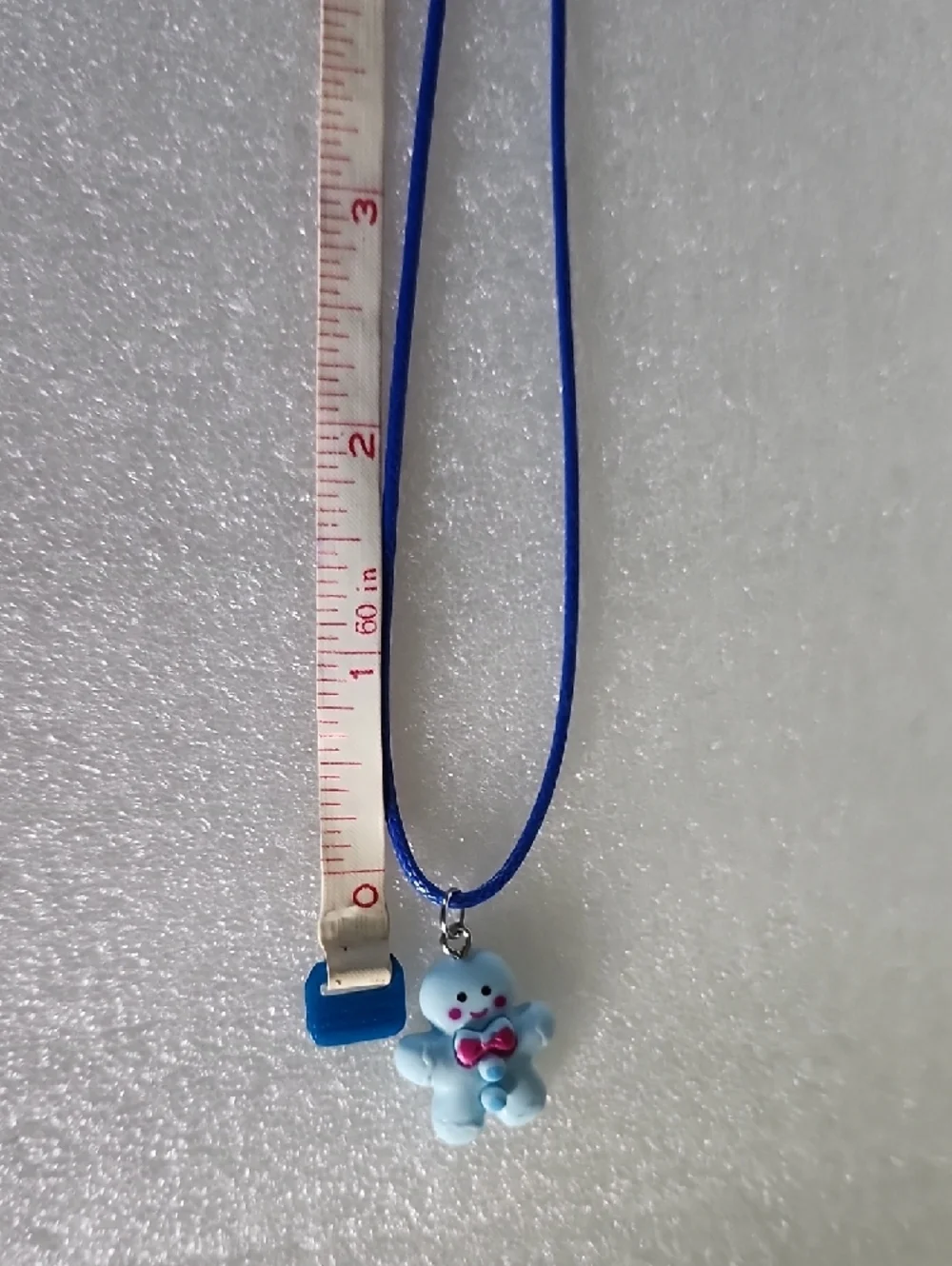 Hand Crafted Blue Gingerbread Man Necklace with Pink Bow